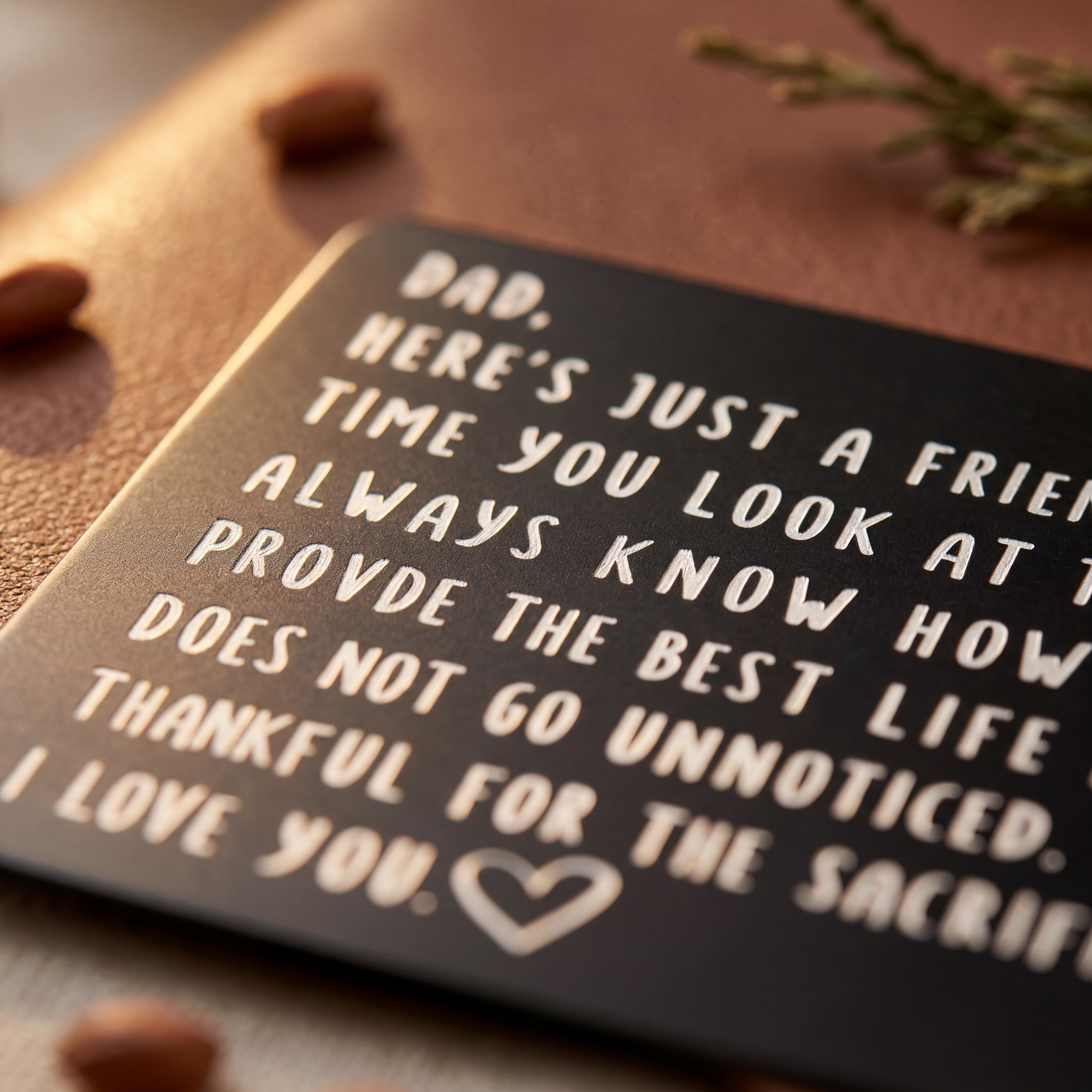 Laser-engraved 'To My Dad' wallet card on warm brown leather background