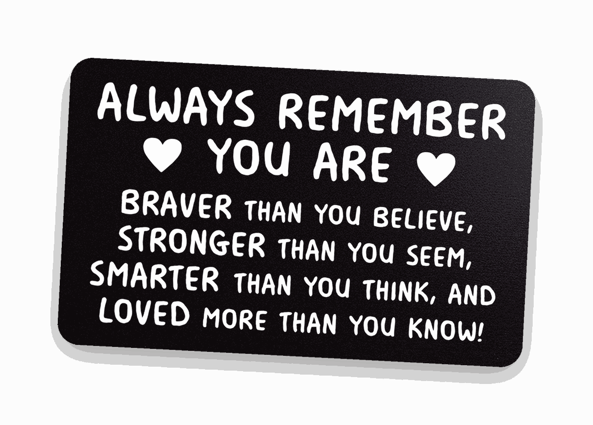 Black engraved 'Always remember you are braver than you believe' metal wallet card on warm linen — graduation keepsake