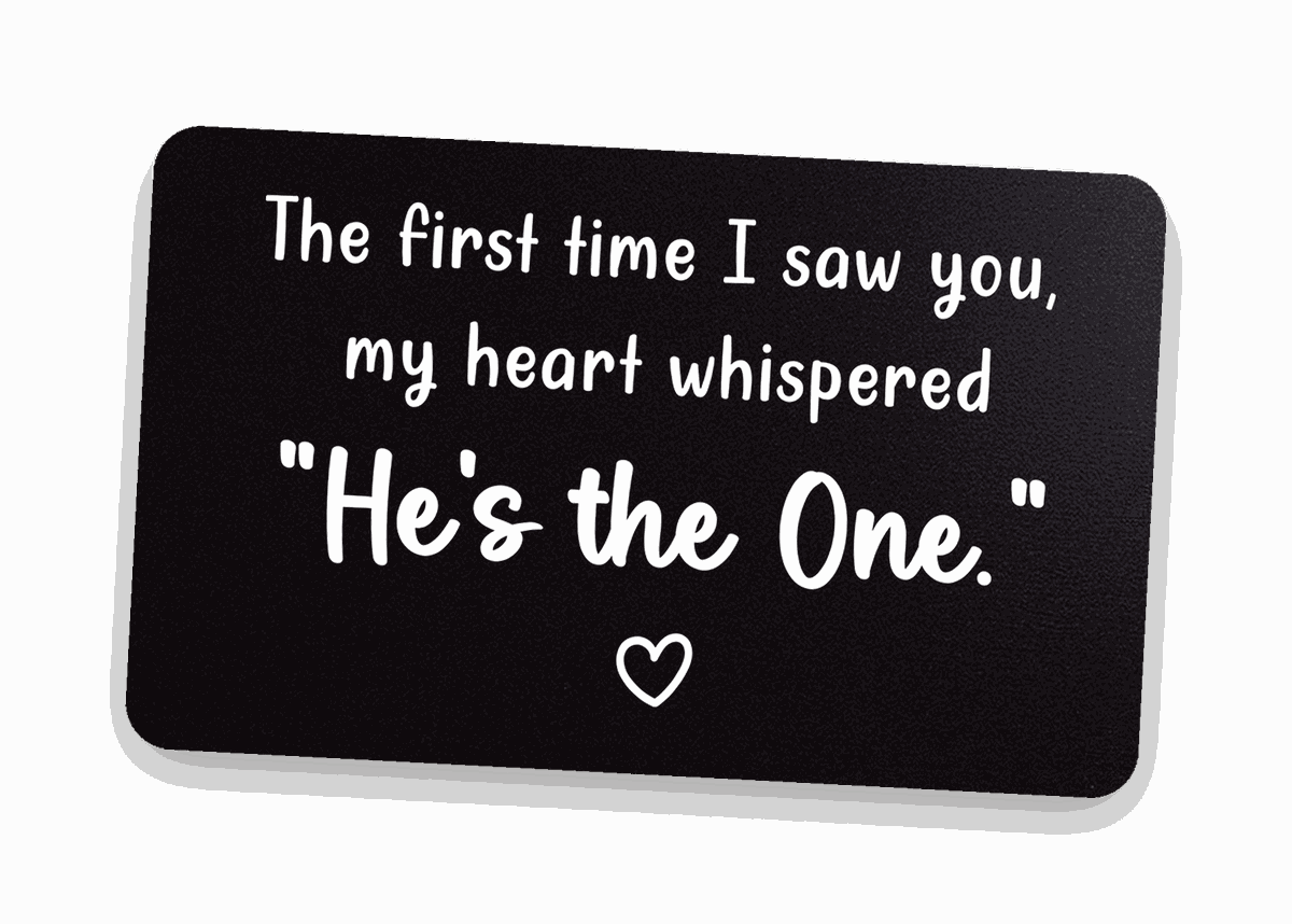 Black engraved 'He's the One' metal wallet card on warm linen — metal anniversary keepsake gift